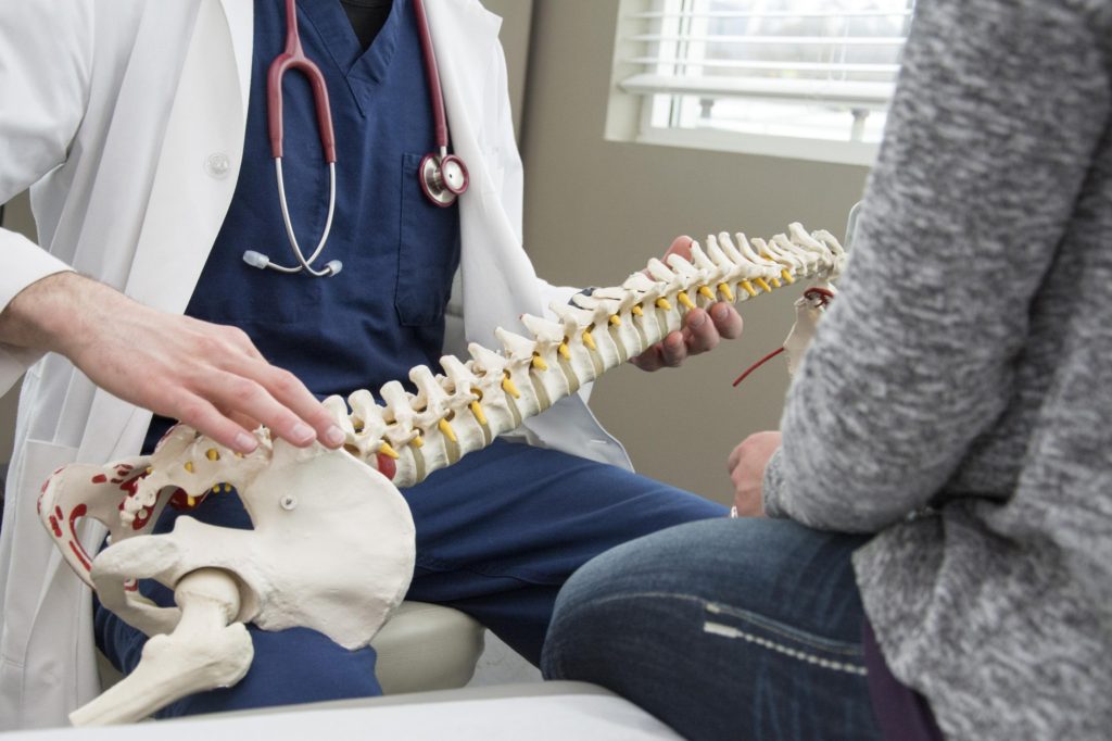 Clinician reviewing a spine model with a patient