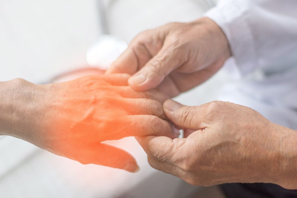 Clinician checking sensation in a patient’s foot