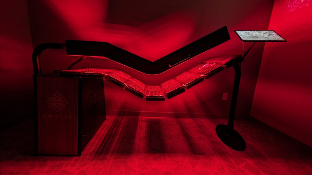 Red light treatment bed used within a wellness program