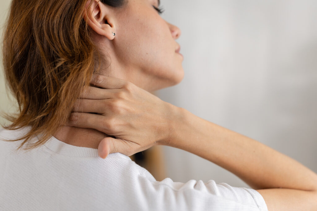 Clinician evaluating neck movement during a patient visit